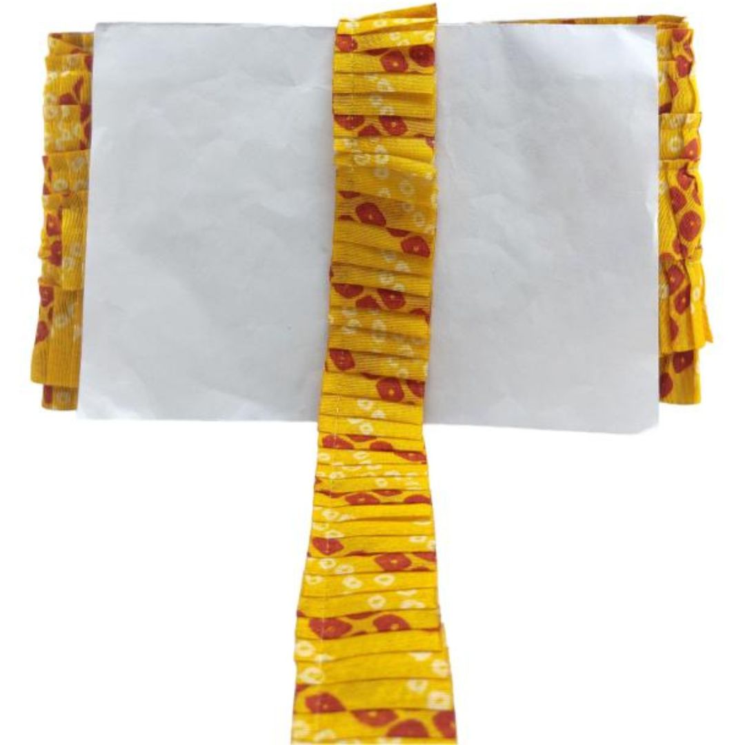 Yellow fabric with red patterns on a white background